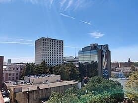 A city skyline featuring tall buildings under a clear blue sky. A city skyline featuring tall buildings under a clear blue sky.