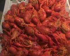 A large pile of cooked, red crawfish.