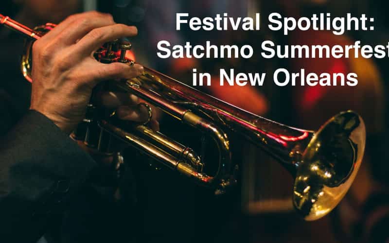 A close-up of a hand holding a trumpet with a blurred background, promoting Satchmo Summerfest in New Orleans. A close-up of a hand holding a trumpet with a blurred background, promoting Satchmo Summerfest in New Orleans.