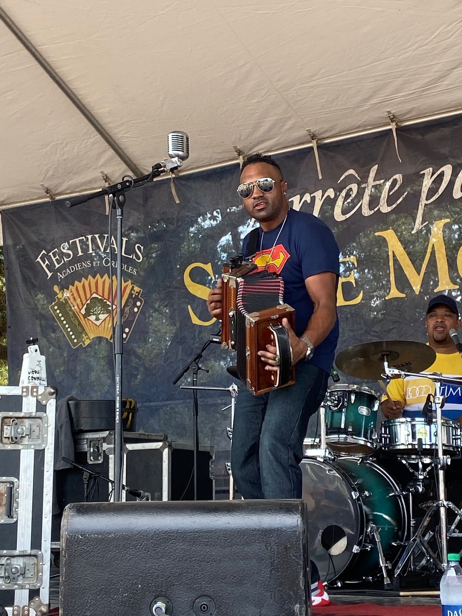 A musician plays the accordion on stage at a festival. A musician plays the accordion on stage at a festival.