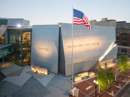 National WWII Museum in New Orleans with American flag in front